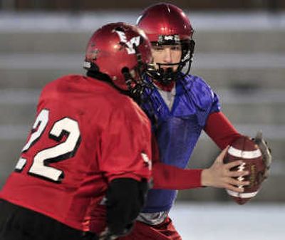 
EWU  QB Matt Nichols, handing the ball to Dale Morris during Tuesday's practice, has praised coach Paul Wulff's attributes. Associated Press
 (Associated Press / The Spokesman-Review)