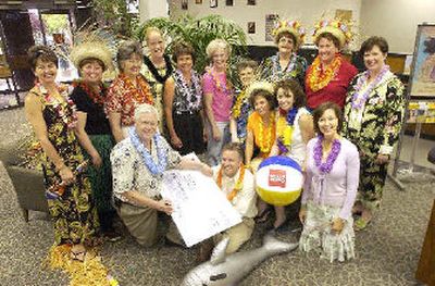 Kneeling at center, Senior Vice President Wayne Schneider and Ted Hanson, (seated on floor) of Wells Fargo Bank pose for a picture after giving EXCEL Foundation representatives the first big donation, $5,000, for the September gala event called the Hula Happening. Gathered for the photo are, from left, Heather Bowlby, Nancy White, Kathy Green, Kimberly Miller, Kathy Meeker, Marilyn Griffitts, Betty Cheeley, Heidi Rogers, Sandie Rolphe, Liese Thompson, Claudia Brennan, Denise Leonard and Shelley Fitzgerald.
 (Jesse Tinsley / The Spokesman-Review)