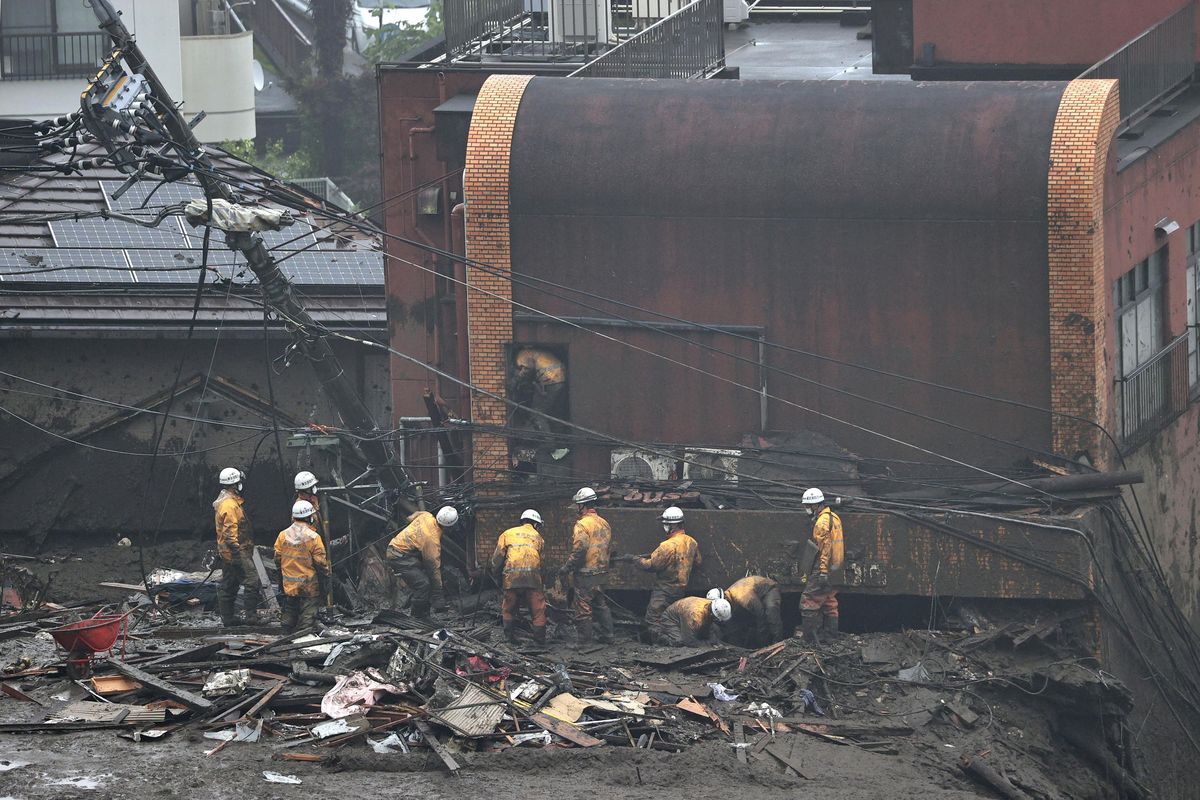 Rescuers conduct a search operation at the site of a mudslide at Izusan in Atami, Shizuoka prefecture, southwest of Tokyo, Sunday, July 4, 2021. More than 1,000 soldiers, firefighters and police on Sunday waded through a giant mudslide that ripped through the resort town as it swept away houses and cars.  (SUB)