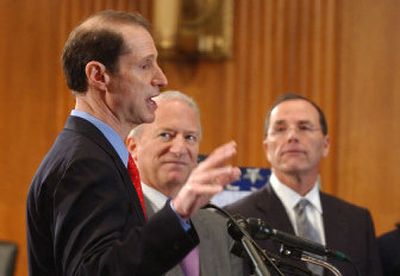 
Sen. Ron Wyden, D-Ore., left, discusses his health plan Wednesday. From left are Wyden,  SEIU President Andy Stern and Safeway President Steve Burd. 
 (Associated Press / The Spokesman-Review)