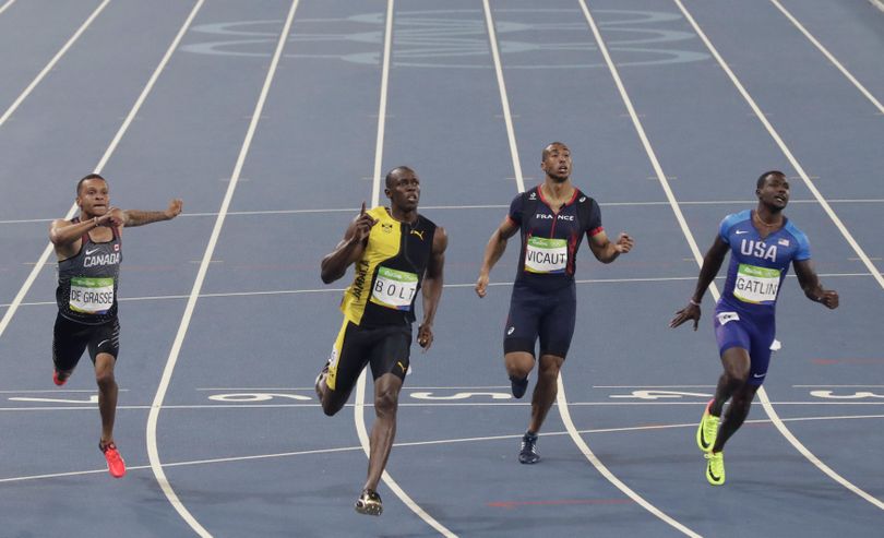 Jamaica’s Usain Bolt, second from left, wins the men’s 100-meter final ahead of Canada's Andre De Grasse, left, United States’ Justin Gatlin and France's Jimmy Vicaut, center. (Martin Meissner / Associated Press)