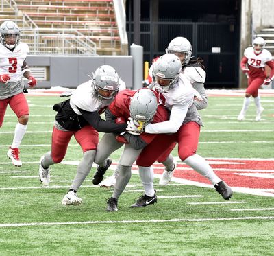 Washington State's Armani Marsh (left) and Justus Rogers (right) converge on the ballcarrier during the Cougars' scrimmage Saturday afternoon at Martin Stadium.  (Washington State Athletics)