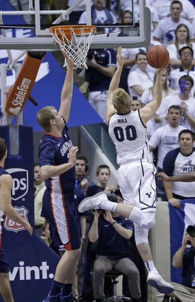 Brigham Young's Eric Mika, right, goes to the basket as Gonzaga's Przemek Karnowski defends. (Associated Press)