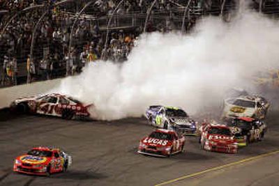 
Casey Mears (41) rubs the wall as several other drivers try to control their cars during the NASCAR Chevy Rock & Roll 400. 
 (Associated Press / The Spokesman-Review)