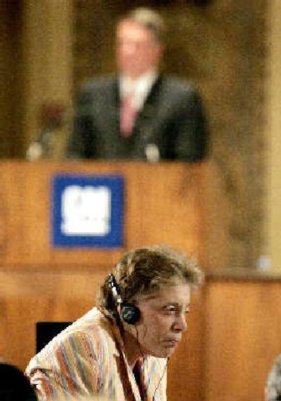 
General Motors stockholder Evelyn Davis, bottom, walks back to her seat after addressing GM Chairman and CEO Rick Wagoner, top, during the company's annual stockholders meeting in Wilmington, Del., on Tuesday.
 (Associated Press / The Spokesman-Review)