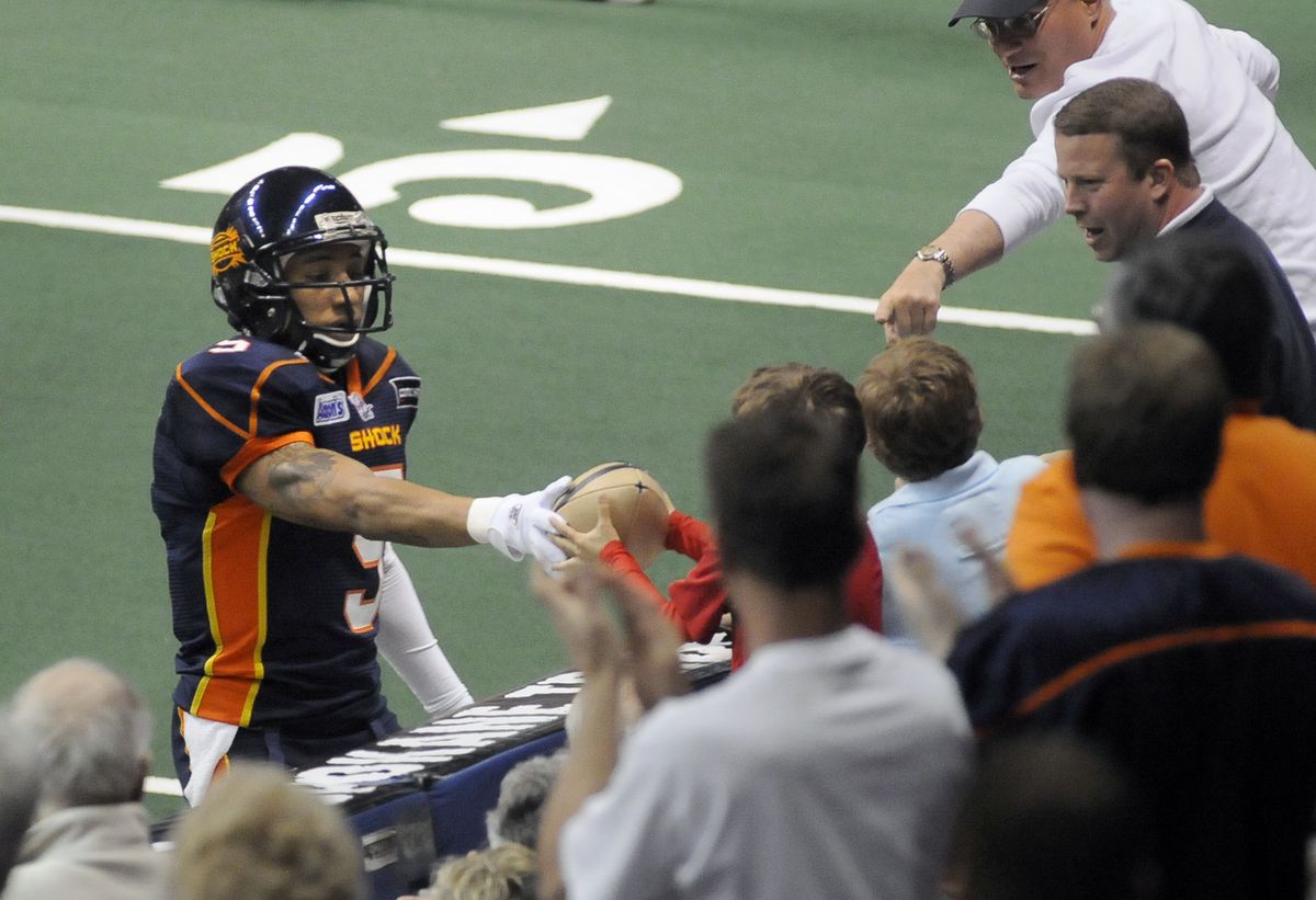 Spokane Shock receiver Charles Dillon awards the ball to a young fan after scoring a touchdown against Iowa on May 2 at the Arena.  (Dan Pelle / The Spokesman-Review)