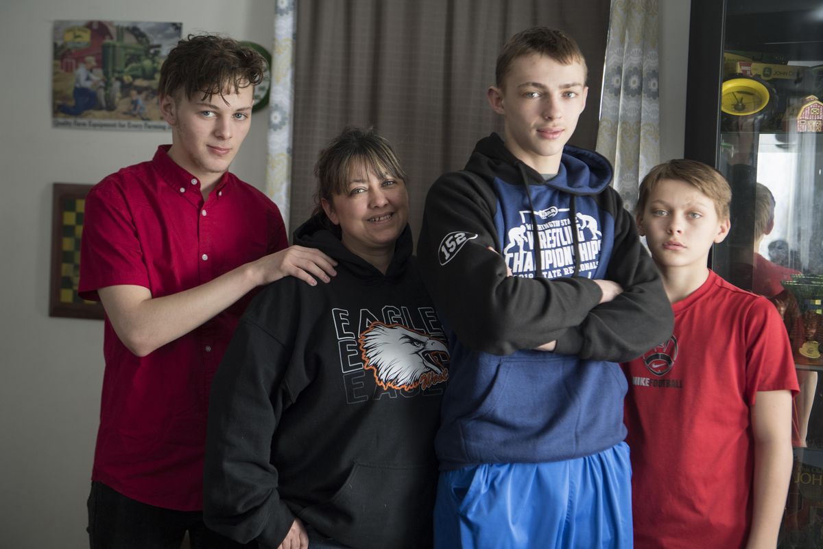 Tabitha Caro is proud of all her boys, from left, Gaven Sterling, Gaje Caro and Wesley Caro, shown Feb. 14 at their home in Millwood. The family is part of a dynasty of wrestlers. (Jesse Tinsley / The Spokesman-Review)