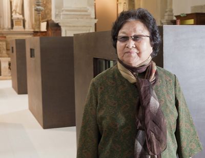 Chinese artist Ai Weiwei’s mother, Gao Ying, poses next to six containers that are part of an installation by her son during a press preview of the 55th edition of the Venice Biennale of Arts in Venice, northern Italy. (Associated Press)