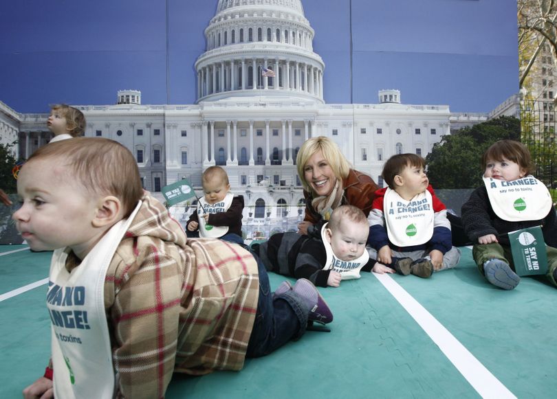 Environmental activist Erin Brockovich mixes it up on a mat with toddlers during an appearance to promote a virtual Million Baby Crawl in New York, Wednesday, Nov. 18, 2009.  The Million Baby Crawl is a grassroots effort to raise awareness about the nation's outdated chemical laws. Advocates hope to encourage Congress to pass stronger regulations against hazardous chemicals in household products. (Kathy Willens / Associated Press)
