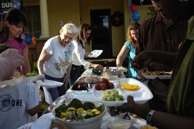 
Virginia Litzenberger, second from left, hands out plates while neighbors and friends sample the potluck at the National Night Out Against Crime party at her West Mallon Avenue home Tuesday. Litzenberger has hosted 23 such parties. 
 (Holly Pickett / The Spokesman-Review)