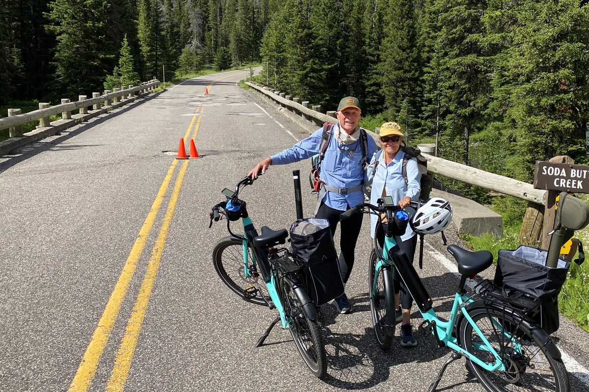 Part-time Silver Gate, Montana, residents Mike Menzel and Kathryn Iverson ride their electric bikes into the park to fish Soda Butte Creek on July 22. They appreciated the diminished crowds but acknowledged the economic hardship for local businesses.  (BRETT FRENCH, Billings Gazette)