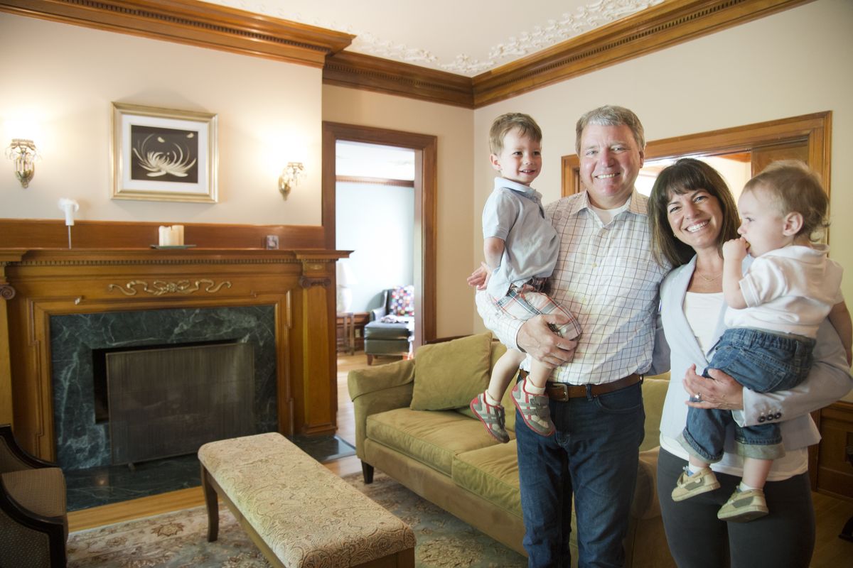 Pete and Amy Chase, with their two children, Alex, 3, and Atticus, 1, stand in the living room of the Morgan House, which they have owned since 2009. (Jesse Tinsley)
