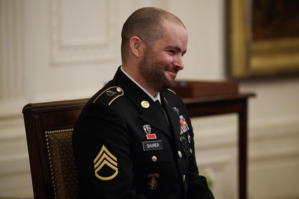 Former Army Staff Sgt. Ronald J. Shurer II smiles at his family before being awarded the Congressional Medal of Honor for actions in Afghanistan, in the East Room of the White House, Monday, Oct. 1, 2018, in Washington. (Evan Vucci / AP)