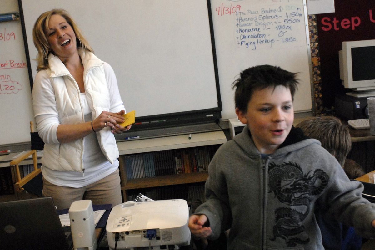Seth Woodard Elementary School PACE teacher Haley Murray laughs after fourth-grader Jamus Conley shared the fate of his group, “Revenant Dragons,” after drawing a card in a simulation game where the students go through the process of becoming a colony. (Photos by J. Bart Reyniak / The Spokesman-Review)