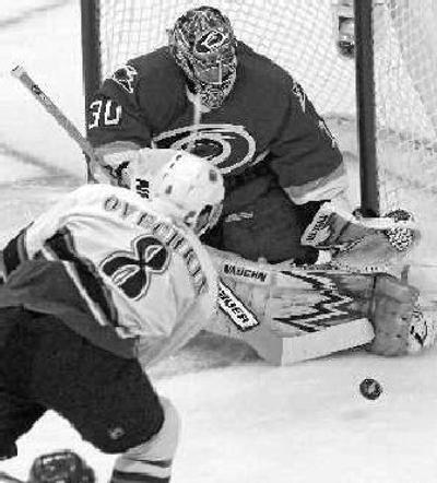 
Carolina Hurricanes goalie Cam Ward, top, blocks the shot of Washington Capitals' Alexander Ovechkin. 
 (The Spokesman-Review)