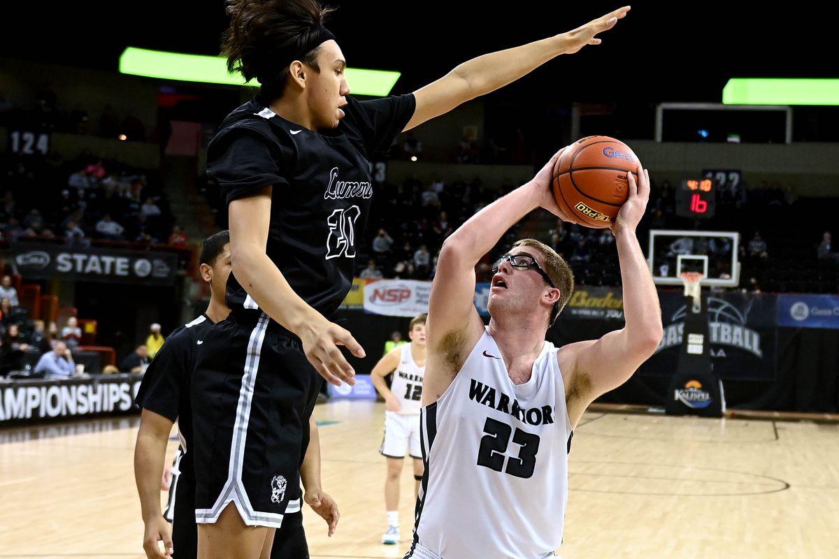 Lummi Nation’s Richard Wilson (20) tries to stop a shot by Almira Coulee Hartline’s Reece Isaak (23) during a quarterfinal WIAA 1B State high school basketball game, Thursday, March 3, 2022, in the Spokane Arena.  (COLIN MULVANY/THE SPOKESMAN-REVIEW)