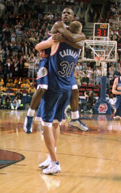 In this 1999 file photo, Gonzaga guard Quentin Hall hugs teammate Casey Calvary (31) after Calvary tipped in the winning basket to beat Florida in the Sweet 16. (Colin Mulvany / The Spokesman-Review)