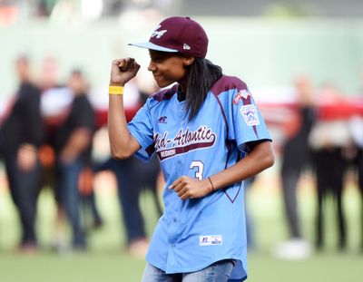 Little League World Series record-setter Mo’ne Davis gestures Saturday before throwing out the ceremonial first pitch at the World Series. (Associated Press)