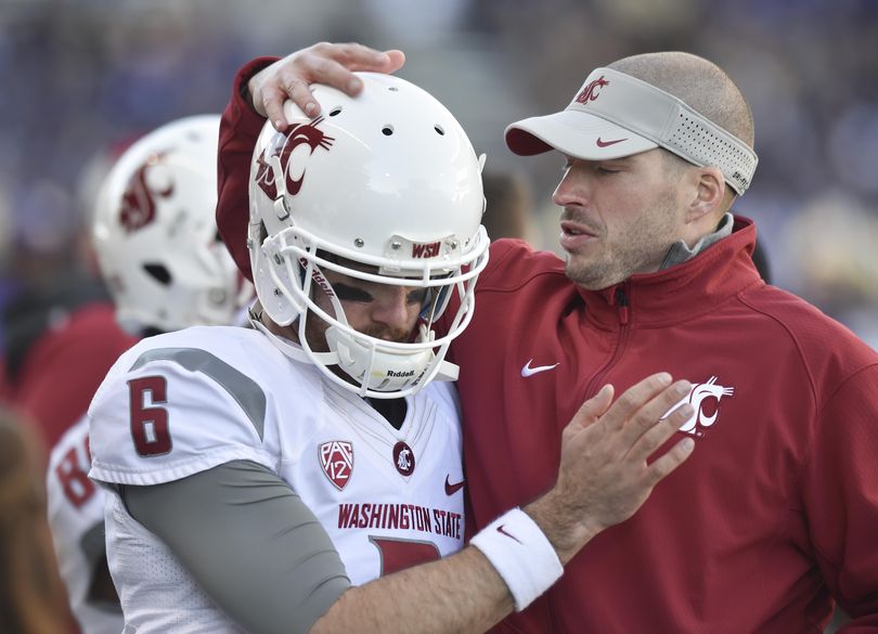 Defensive coordinator Alex Grinch, cheering on quarterback Peyton Bender, has had his contract extended at WSU. (Tyler Tjomsland / The Spokesman-Review)