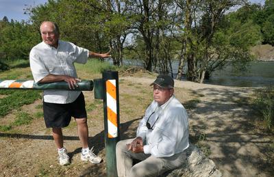 Tim Reed and Stann Grater, shown at the padlocked Water Street boat launch in Peaceful Valley, are seeking greater Spokane River access in Spokane.  (Dan Pelle / The Spokesman-Review)