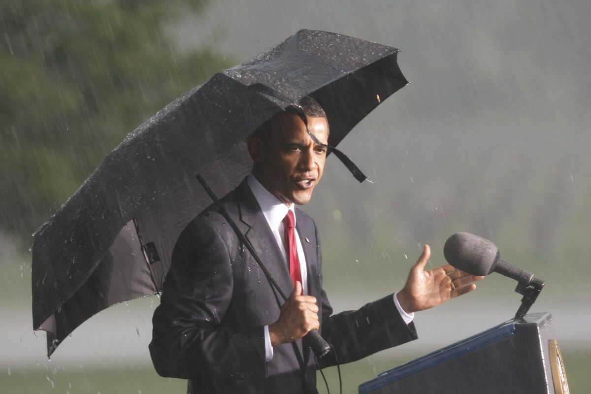 President Barack Obama takes the stage in a rainstorm  during Memorial Day ceremonies in Elwood, Ill., on Monday. Associated Press photos (Associated Press photos)