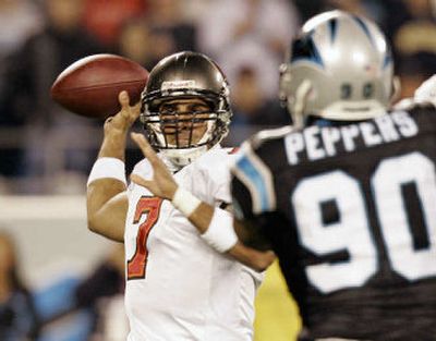 
Tampa Bay's Bruce Gradkowski was harassed all night by Julius Peppers, who took over the NFL sack lead with three. 
 (Associated Press / The Spokesman-Review)