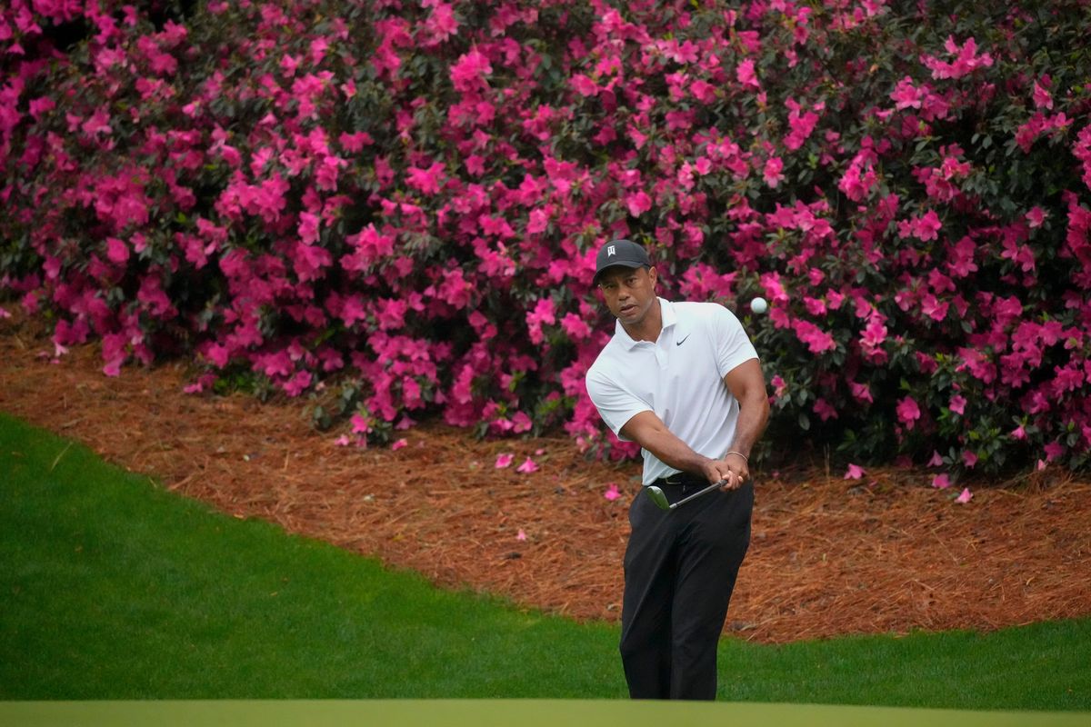 Tiger Woods chips to the green on the 13th hole during a practice round for the Masters golf tournament on Wednesday, April 6, 2022, in Augusta, Ga.  (Charlie Riedel)