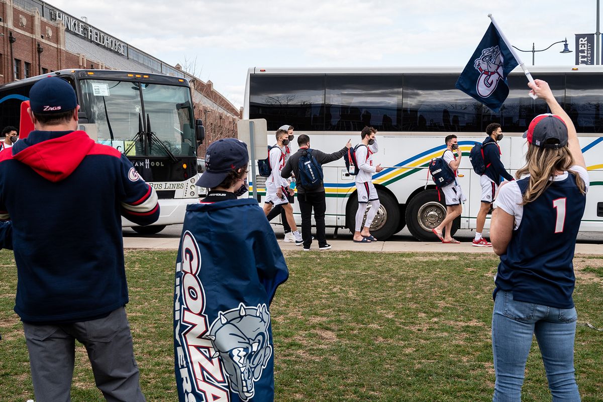 The Malone family of Sean, left, Reilly, 12, and mom, Courtney, cheer on the Zags as they board buses at Butler University’s Hinkle Fieldhouse after the Gonzaga defeated Oklahoma 87-71 on Monday.  (COLIN MULVANY/THE SPOKESMAN-REVIEW)