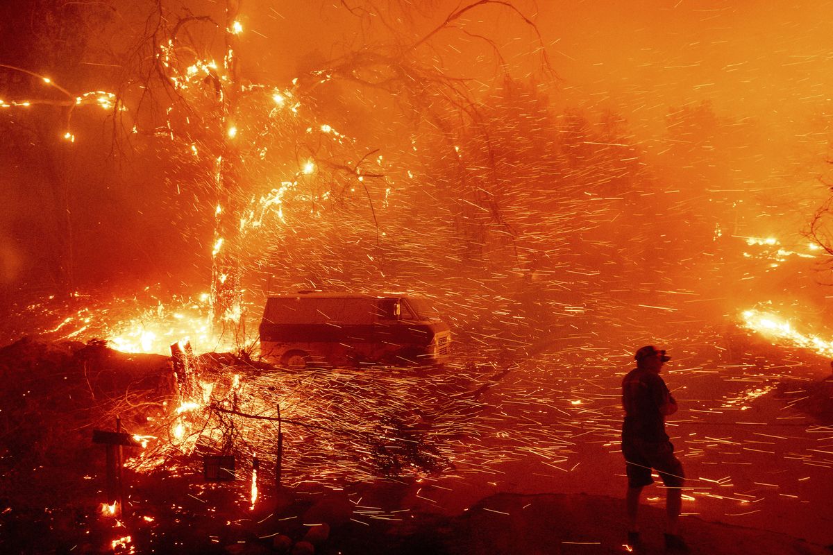 Bruce McDougal prepares to defend his home as the Bond Fire burns though the Silverado community in Orange County, Calif., on Thursday, Dec. 3, 2020. (Noah Berger)