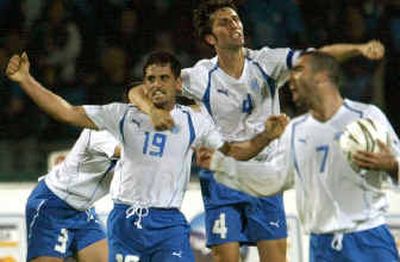 
Israel's Abas Suan, left, and Arik Benado, center, express their joy after Suan scored during a World Cup qualifying match against Ireland last Saturday. 
 (Associated Press / The Spokesman-Review)