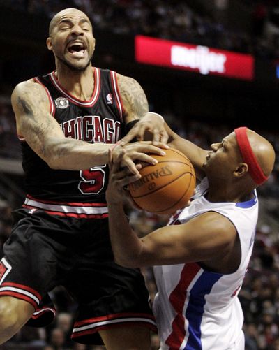 After blowing a fourth-quarter lead and getting a little help from Carlos Boozer (5), the Bulls were able to put away the Pistons. (Associated Press)