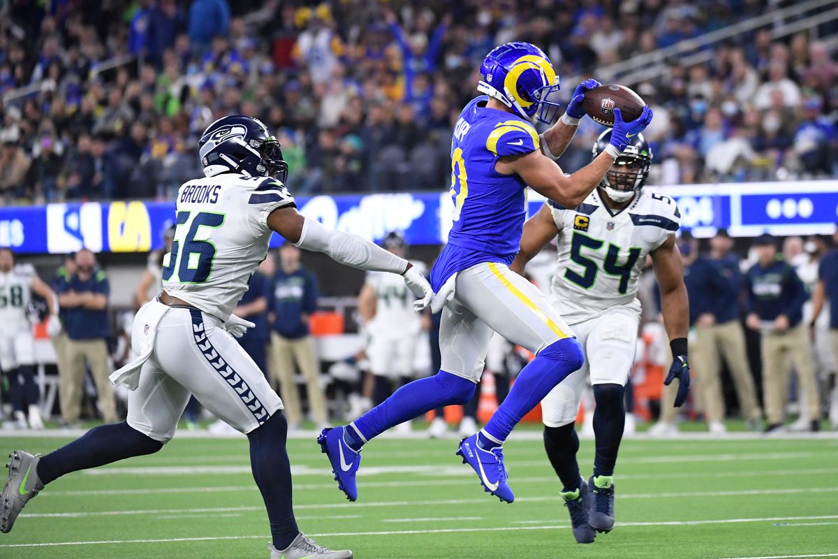 Los Angeles Rams wide receiver Cooper Kupp, defended by Seahawks outside linebacker Jordyn Brooks and middle linebacker Bobby Wagner, catches a pass on his way to a second-half touchdown Tuesday.  (Associated Press)