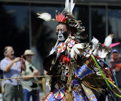Nathan Chasing Horse, center, dances in the arena Saturday, July 21, 2012 at the Julyamsh Powwow at the Coeur d'Alene Greyhound Park. Chasing Horse is a Lakota Sioux native who travels the powwow circuit and was asked to judge some of the dancing divisions. (Jesse Tinsley/SR file photo)
