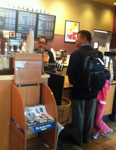 Gary Locke, the new U.S. ambassador to China, at an airport Starbucks. (Associated Press)