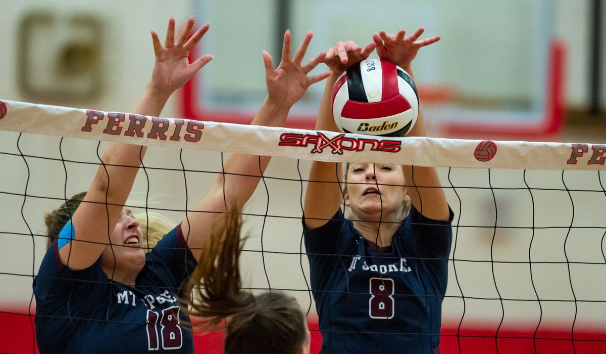 Haley Hodge (18) and Katie Rhodes (8) of Mt. Spokane attempt to block a ball from Ferris in the first set on Sept. 18, 2018 at Ferris High School in Spokane, Wash. The Mt. Spokane Wildcats beat the Ferris Saxons 3-0. (Libby Kamrowski / The Spokesman-Review)