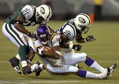 
Nate Burleson is tackled by Jets Derrick Strait, left, and Erik Coleman.
 (Associated Press / The Spokesman-Review)