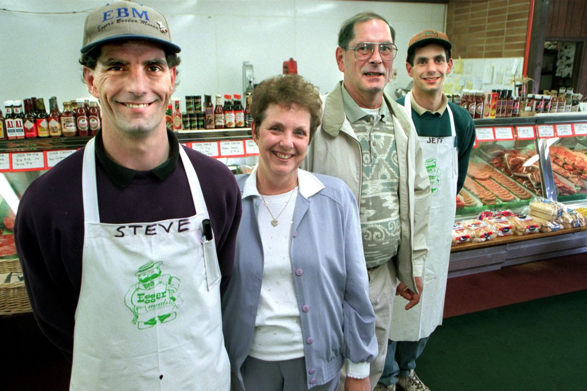Cathy and Bob Egger, center, are surrounded by their sons Steve, left, and Jeff in 1999 at their south side market located at 5613 S. Perry St. in Spokane.  (The Spokesman-Review photo archive)
