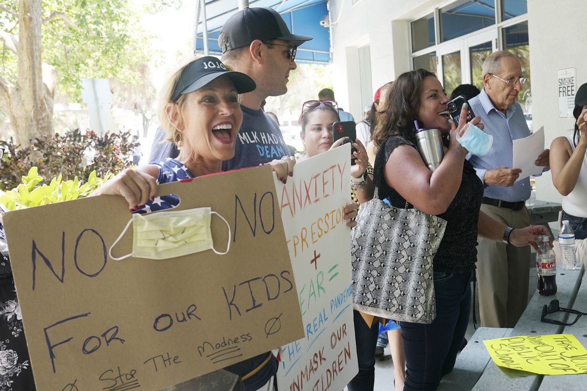 Joann Marcus of Fort Lauderdale, left, cheers as she listens to the Broward School Board