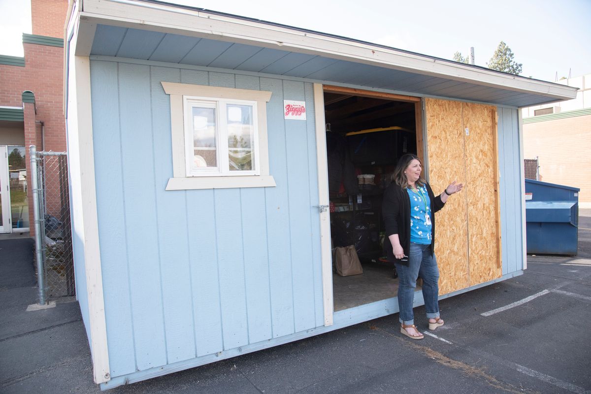 Jennifer Boomer, head of the PTO at Evergreen Elementary in North Spokane, stands by a shed outside the school which is serving as a clothes closet for storing extra clothing donated for students who need extra clothes during the school day for a variety of reasons.  (Jesse Tinsley/The Spokesman-Review)