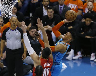 Oklahoma City Thunder guard Russell Westbrook, right, shoots in front of Portland Trail Blazers center Enes Kanter (00) I the first half of Game 3 of an NBA basketball first-round playoff series Friday, April 19, 2019, in Oklahoma City. (Sue Ogrocki / Associated Press)