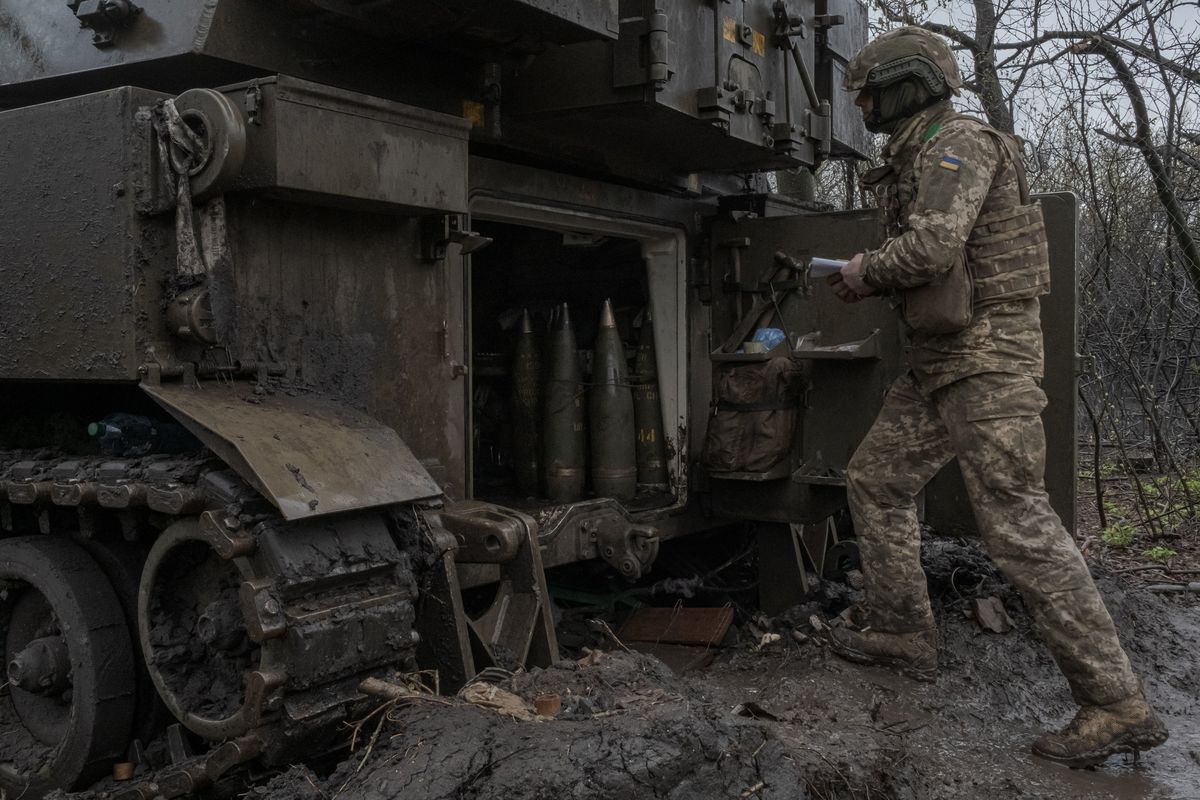 A Ukrainian soldier talks to crew members as they load 155mm shells to be fired from an American-made M109 Paladin self-propelled howitzer towards positions of Russian troops stationed inside Bakhmut, on the western outskirts of Bakhmut, in eastern Ukraine, April 14, 2023. The European Union lifted tariffs on Ukrainian grain last year, but a glut of produce in Europe had seen the livelihoods of farmers suffer. (Mauricio Lima/The New York Times)  (MAURICIO LIMA)