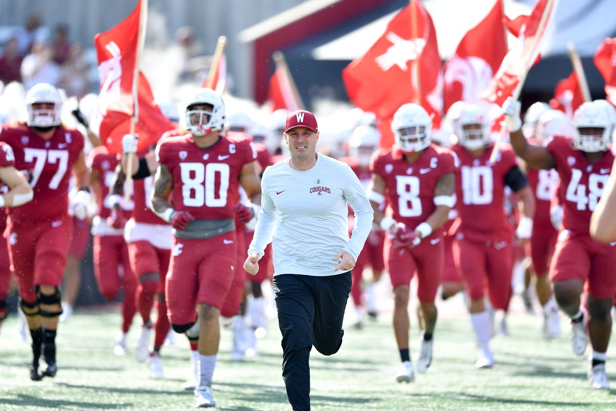 Washington State coach Jake Dickert leads his team out of the tunnel before a Pac-12 game against Cal on Saturday at Gesa Field in Pullman.  (Tyler Tjomsland/The Spokesman-Review)