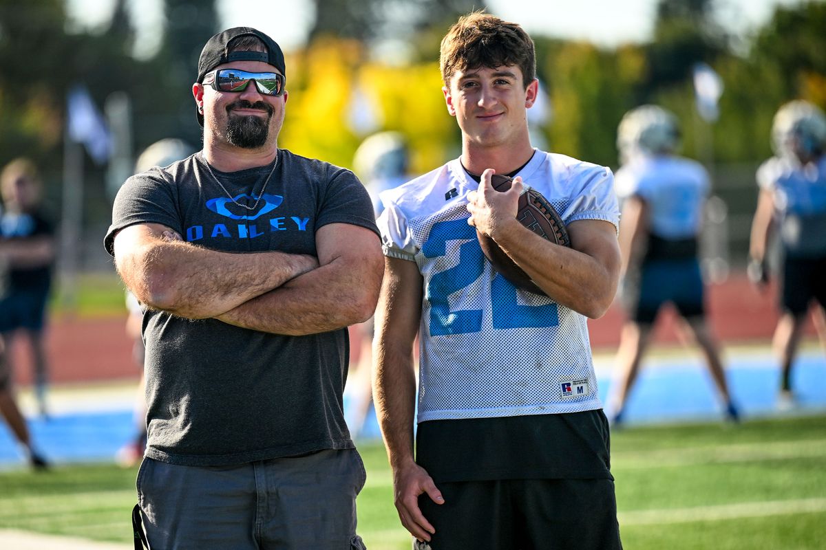 Scott Campbell, left, poses Tuesday at Central Valley High with CV senior Beau Butner who broke Campbell’s single-game rushing record Friday night.  (Kathy Plonka/The Spokesman-Revie)