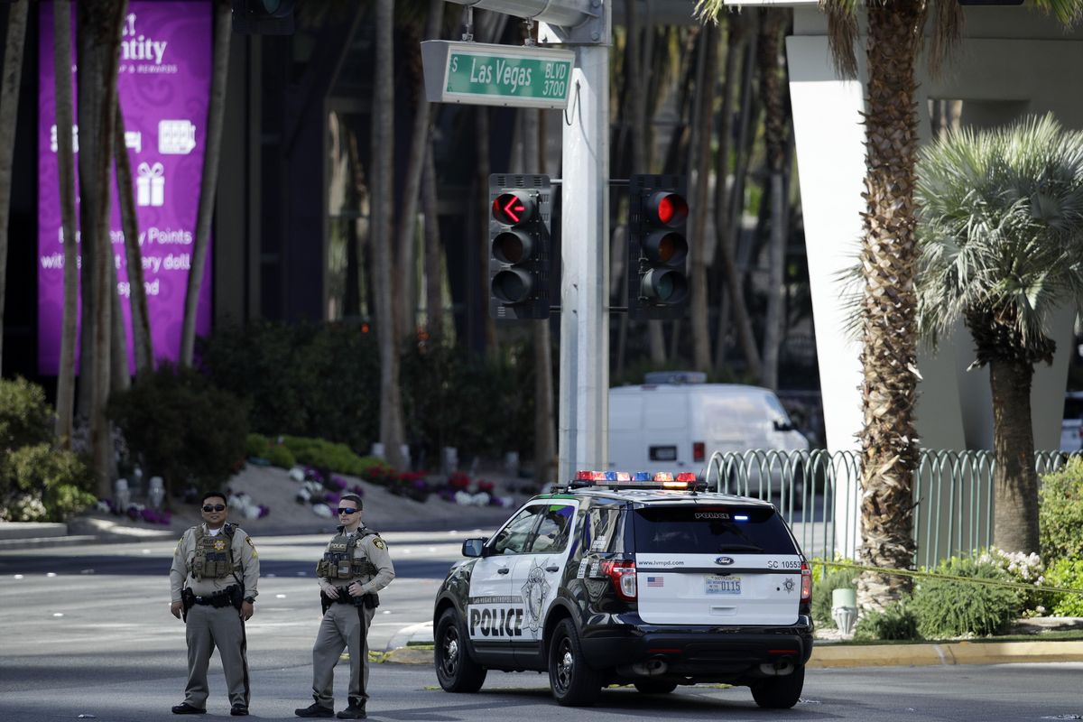Police officers stand along Las Vegas Boulevard, Saturday, in Las Vegas. Police Part of the Strip was closed for several hours after a shooting. (John Locher / Associated Press)