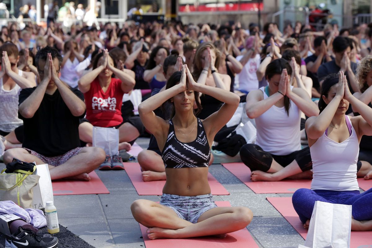 Thousands of New Yorkers mark the first day of summer Saturday by practicing yoga during the 12th annual Solstice in Times Square. (Associated Press)