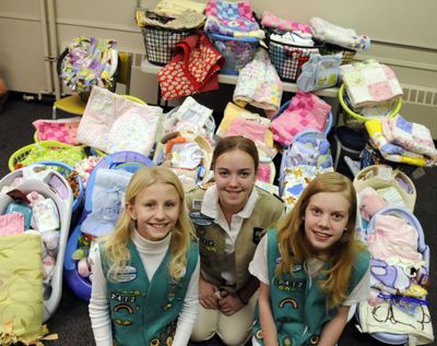 Selena Elliott, Erin Buck and Monica Troxel of Girl Scout Troop 2472 spent many hours making 51 layettes for babies at the Spokane Valley Partners as a part of their Bronze Award, the highest honor that Junior Girl Scouts can attain. All the items in the baskets were donated.bartr@spokesman.com (J. BART RAYNIAK)