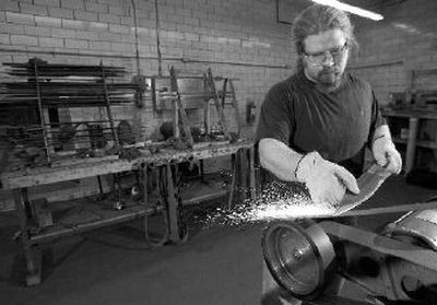 
Joe Waite grinds an edge on a sword Thursday in New Glarus, Wis., at Albion Swords. 
 (Associated Press / The Spokesman-Review)