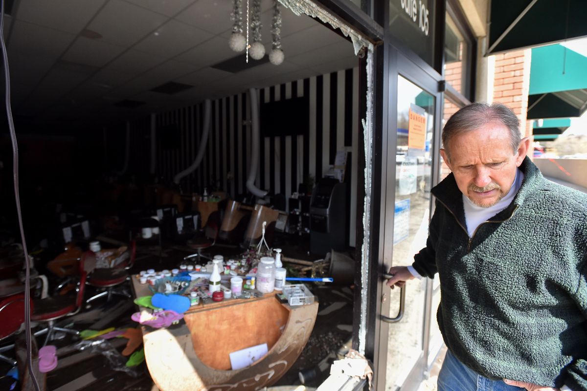 Parley Pearce, of Walla Walla, stands in the doorway of a building he owns at 745 N. Grand Ave. in Pullman on Wednesday, April 10, 2019, showing how one of his tenant’s businesses – a nail salon – was torn up during a flash flood the previous night. Firefighters smashed a window to rescue employees who were inside laying sandbags. “These are really hard-working people,” Pearce said. “I hate to see this happen to them.” (Tyler Tjomsland / The Spokesman-Review)