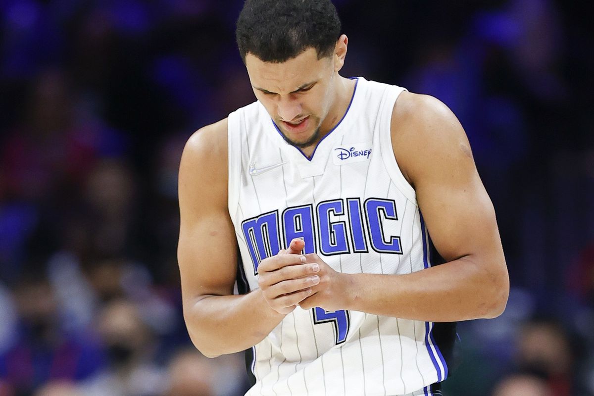 Orlando Magic guard Jalen Suggs holds his hand after injuring it during the fourth quarter against the Sixers on last season.  (Tribune News Service)