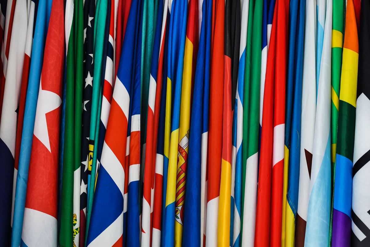 The 31 flags owned by Tomas Lynch are lined up in the order of which they will be displayed from his apartment in Spokane on Monday, June 6, 2022.  (Kathy Plonka/The Spokesman-Review)